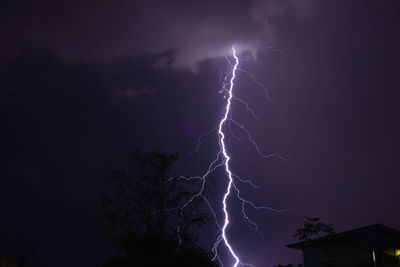 Lightning strike over homes during a summer thunderstorm