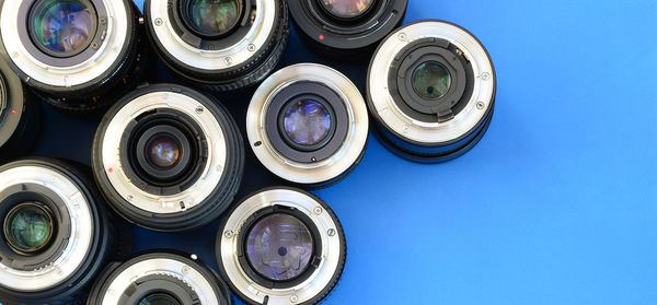 Directly above shot of various lenses on blue background