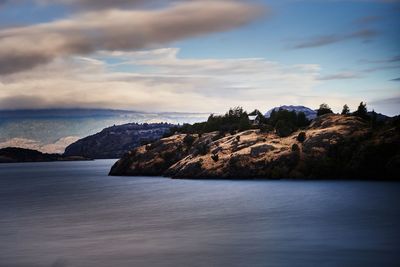 Scenic view of sea and mountains against sky