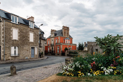 Old cobblestoned street with stone medieval houses in the town centre of dinan, french brittany