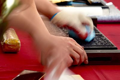 Cropped image of worker cleaning letterpress