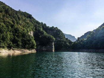 Scenic view of lake and mountains against sky