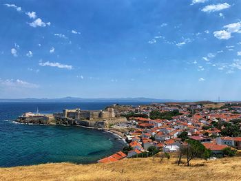 High angle view of townscape by sea against sky