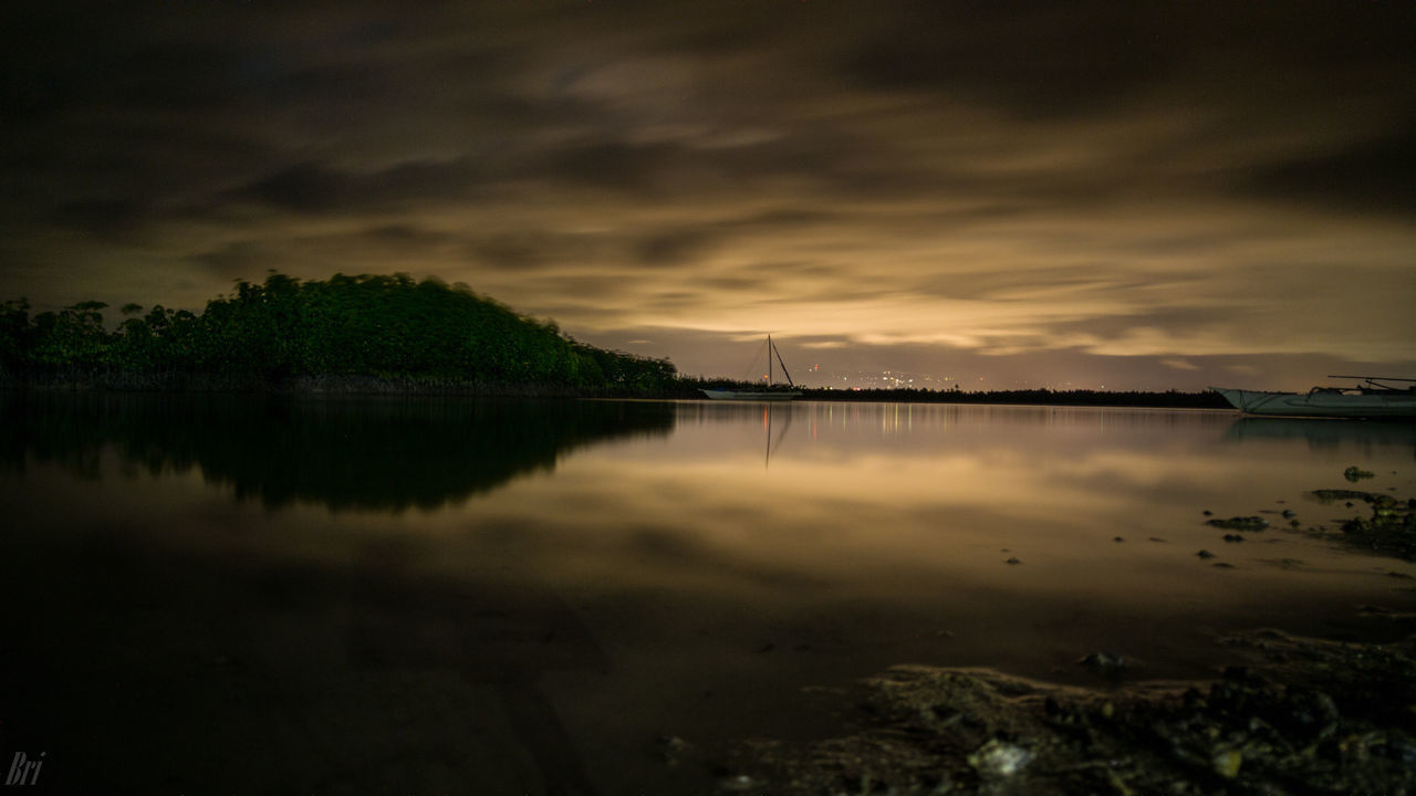 SCENIC VIEW OF LAKE BY TREES AGAINST SKY