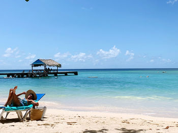 Scenic view of beach against blue sky