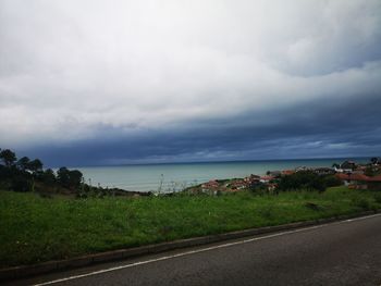 Road by sea against sky in city