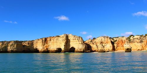 Panoramic view of sea and rocks against sky