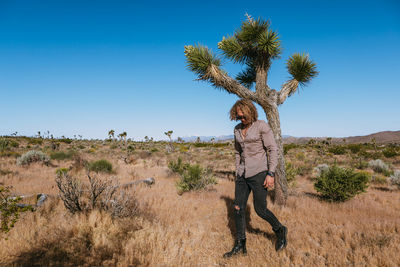 Man standing on field against clear sky