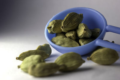 Closeup of dried elettaria cardamomum fruits with seeds, cardamom in small bowl organic elaichi 