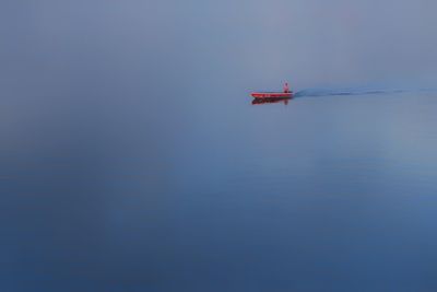 Airplane in water against blue sky