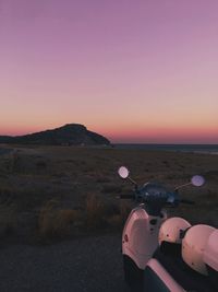 Scooter on road against sky during sunset