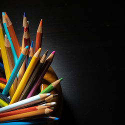 Dramatically lit selection of colored pencils.