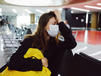 Portrait of woman holding while standing in bus