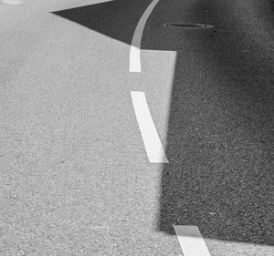 High angle view of arrow symbol on road in city