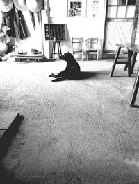 Side view of man sitting on table