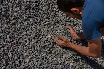 Low section of man standing on road