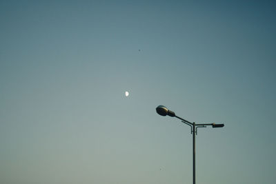 Low angle view of street light against clear sky at dusk