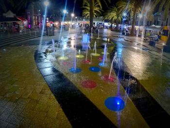 Illuminated city street at night