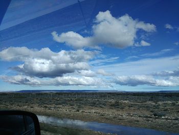 Scenic view of landscape against cloudy sky