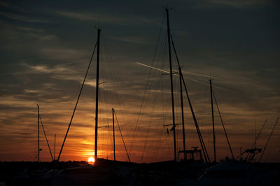 Silhouette sailboats on sea against sky during sunset