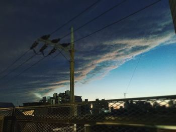 Low angle view of power lines against sky