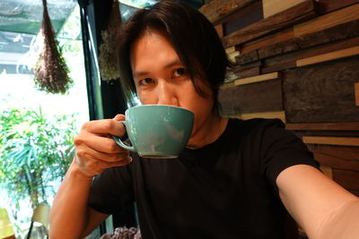 Portrait of man drinking coffee