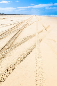 Sand dunes in desert against sky