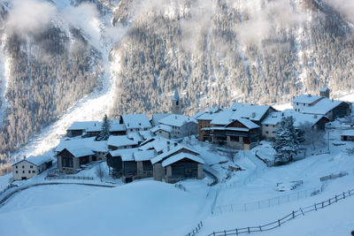 Snow covered houses and buildings in city