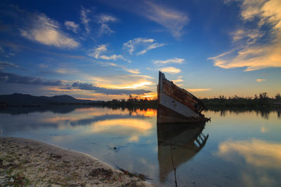 Scenic view of lake against sky during sunset