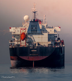 Ship moored in sea against sky