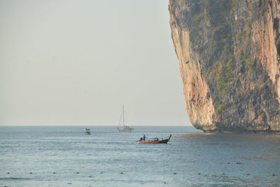 Sailboat sailing on sea against clear sky