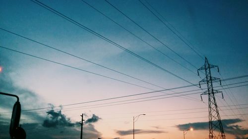 Low angle view of electricity pylon against sky