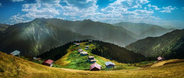 Panoramic view of land and mountains against sky