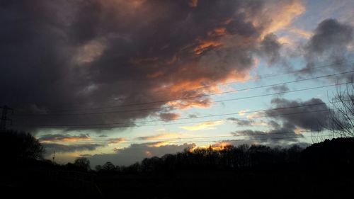 Silhouette of tree against cloudy sky