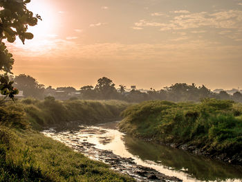 Scenic view of landscape against sky during sunset