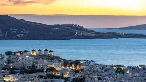 High angle view of townscape by sea against sky