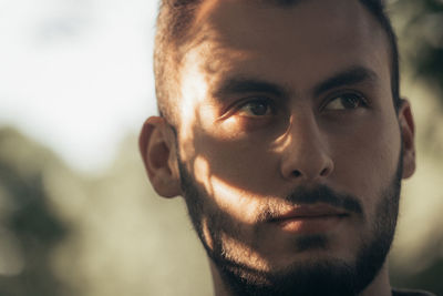 Close-up of bearded man looking away