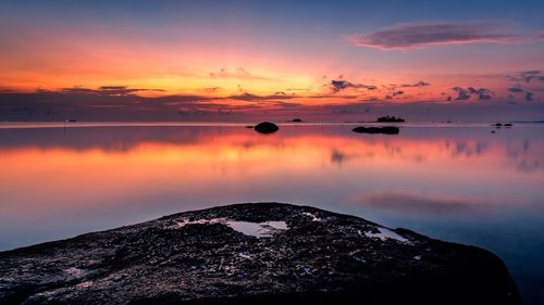 Scenic view of lake at sunset