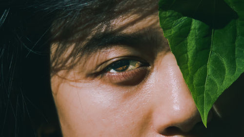 Close-up portrait of woman's eye under the sun