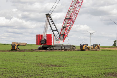 Traditional windmill on field against sky