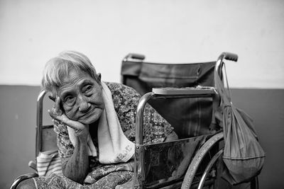 Portrait of woman sitting on chair