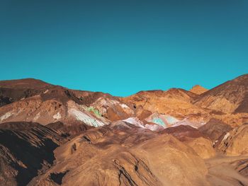 Scenic view of mountains against clear blue sky