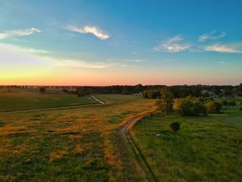 Scenic view of field against sky during sunset