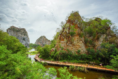 Scenic view of rock formation amidst trees against sky