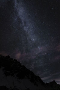 Low angle view of mountain against star field