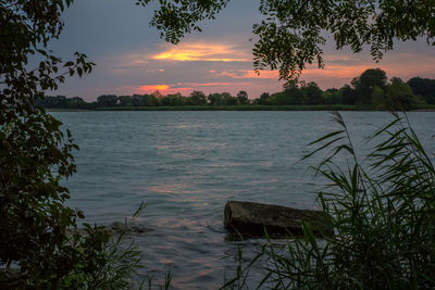 Scenic view of lake against sky during sunset