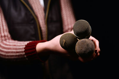 Close-up of woman holding microphones