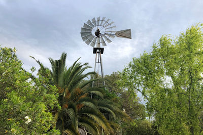 Low angle view of windmill against sky