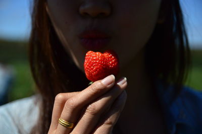 Close-up of woman eating strawberry