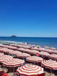 Panoramic view of beach against clear blue sky